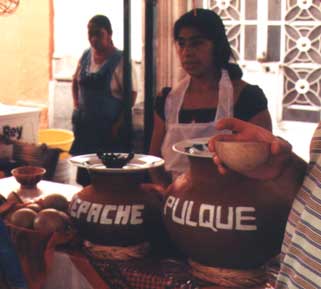 The ancient Pulque drink sold by a street vendor.  Pulque is a milky viscous beverage made by fermenting the fresh sap of Maguey.  References to the drink go back at least 2000 years.  I found it tasty and very smooth. 
